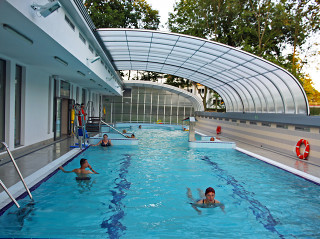 Retractable pool enclosure for public swimming pool