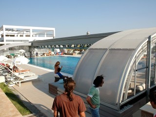 Retractable pool enclosure for public swimming pool