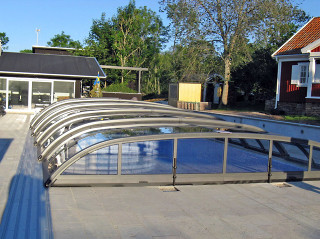 Low pool enclosure ELEGANT in a blooming garden