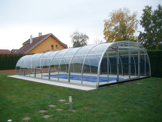 White inground pool cover LAGUNA with sitting set near by