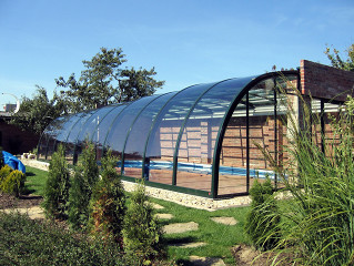 Retractable pool cover STYLE installed directly to the roof construction