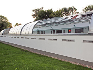 Retractable pool enclosure for public swimming pool