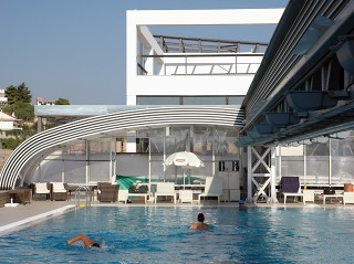 Retractable pool enclosure for public swimming pool