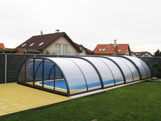 Kids playing in pool covered pool enclosure