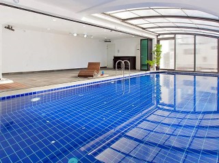 Indoor pool half covered with pool enclosure Style