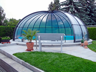 Pool enclosure ORIENT with dark polycarbonate panels and anthracite frames