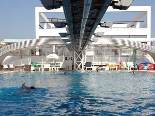 Retractable pool enclosure for public swimming pool