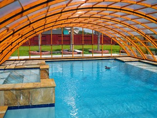 Inside view into pool enclosure Universe NEO with wood imitation finish
