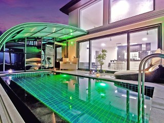 Magnificent night looking on enlightened swimming pool enclosure Style