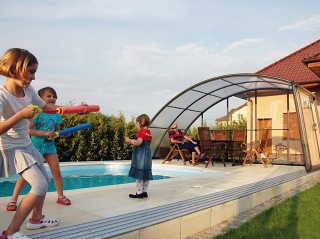 Playing kids near closed pool enclosure Ravena