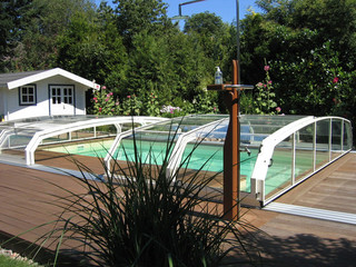 Dark color used on construction of pool cover OCEANIC in a spring meadow