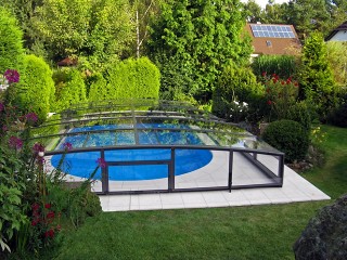 Anthracite finish pool enclosure Viva looks great into blooming garden