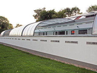 A multi-segment lean-to enclosure used to enclose 30 meters long public pool
