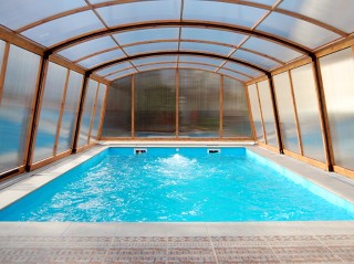 Look into pool enclosure Venezia with wood imitation finish