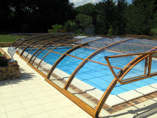 Retractable pool enclosure Elegant NEO with opened front facing segment