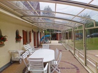 Innovative conservatory - retractable Patio enclosure CORSO by Alukov