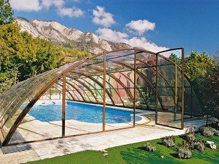 Retractable swimming pool enclosure Universe in brown color with beautiful view to the mountains