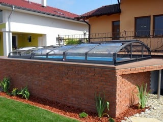 Atypically situated pool covered with IMPERIA pool enclosure