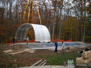 Fitting of first segment of pool enclosure on its place