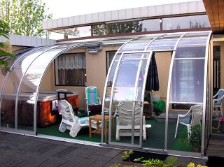 Retractable patio enclosure CORSO Entry attached to a house