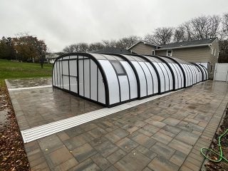 Pool enclosure Laguna attached to house with white polycarbonate for privacy