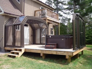 Retractable Oceanic High as patio enclosure over wooden deck and hot tub