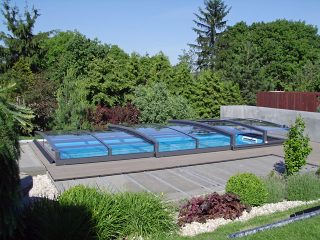 Retractable pool enclosure Viva Prime in the garden