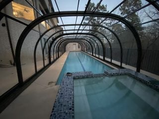 Swimming pool enclosure LAGUNA in the evening