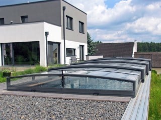 Swimming pool enclosure Viva with modern house in the background